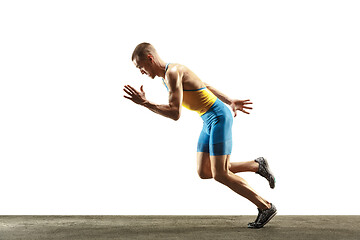 Image showing Young caucasian man running or jogging isolated on white studio background.