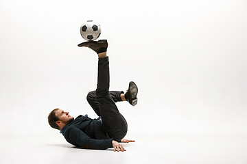 Image showing Businessman with football ball in office