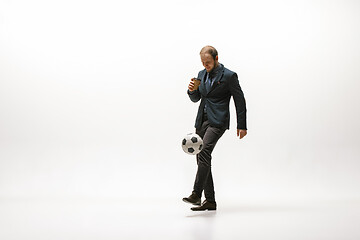 Image showing Businessman with football ball in office