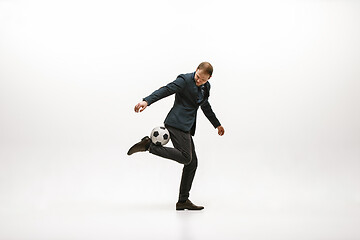 Image showing Businessman with football ball in office