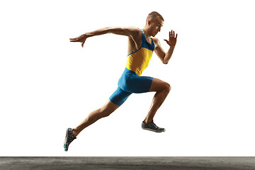 Image showing Young caucasian man running or jogging isolated on white studio background.