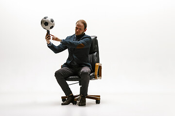 Image showing Businessman with football ball in office