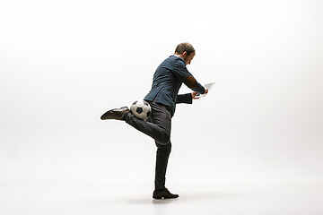 Image showing Businessman with football ball in office