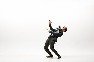 Image showing Businessman with football ball in office