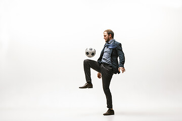 Image showing Businessman with football ball in office