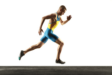 Image showing Young caucasian man running or jogging isolated on white studio background.