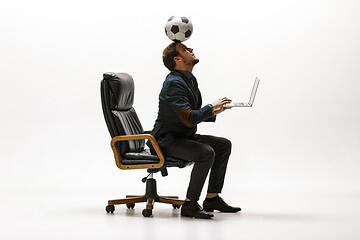 Image showing Businessman with football ball in office