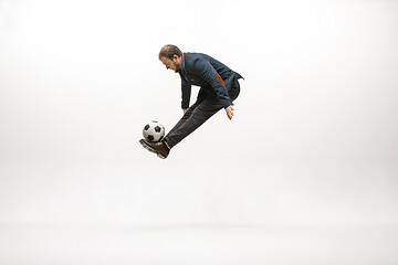 Image showing Businessman with football ball in office