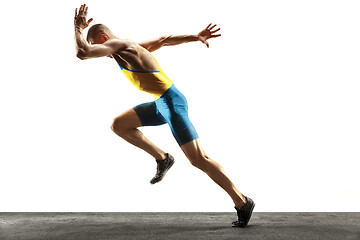 Image showing Young caucasian man running or jogging isolated on white studio background.