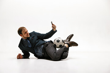 Image showing Businessman with football ball in office