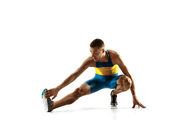 Image showing Young caucasian man running or jogging isolated on white studio background.