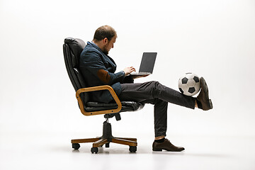 Image showing Businessman with football ball in office