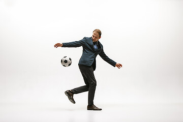 Image showing Businessman with football ball in office