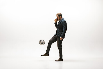 Image showing Businessman with football ball in office