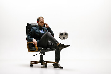 Image showing Businessman with football ball in office