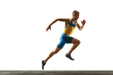 Image showing Young caucasian man running or jogging isolated on white studio background.