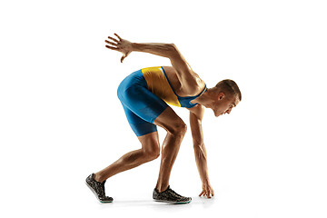 Image showing Young caucasian man running or jogging isolated on white studio background.