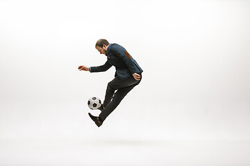 Image showing Businessman with football ball in office