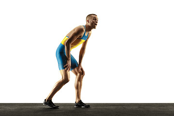 Image showing Young caucasian man running or jogging isolated on white studio background.