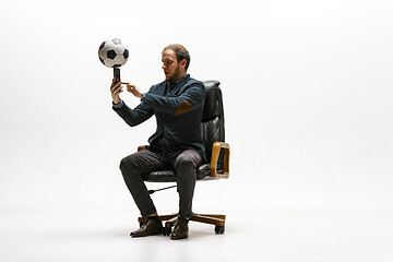 Image showing Businessman with football ball in office