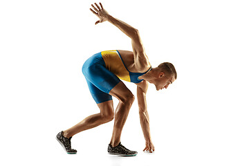 Image showing Young caucasian man running or jogging isolated on white studio background.