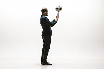 Image showing Businessman with football ball in office