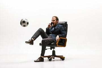 Image showing Businessman with football ball in office