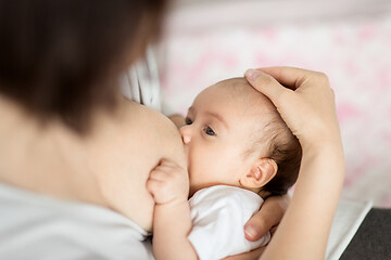 Image showing close up of mother breastfeeding newborn baby