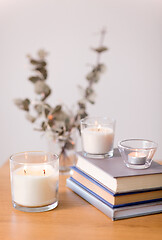 Image showing fragrance candles burning and books on table