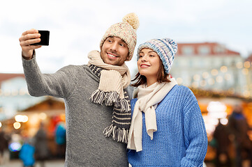 Image showing couple takes selfie by smartphone christmas market