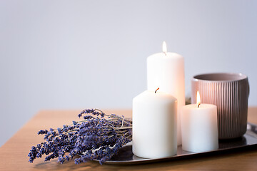 Image showing candles, tea in mug and lavender flowers on table