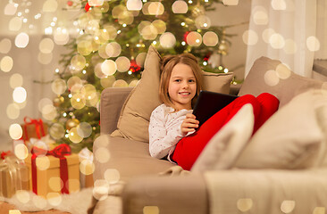 Image showing smiling girl with tablet pc at christmas home