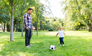 Image showing father with little son playing soccer at park