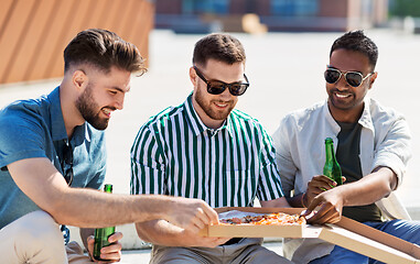 Image showing male friends eating pizza with beer on street