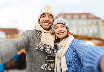 Image showing happy couple taking selfie at christmas market