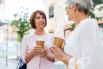 Image showing senior women with shopping bags and coffee in city