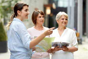 Image showing passerby showing direction to senior women in city