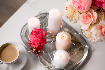 Image showing coffee, candles, garland and flowers on table