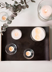 Image showing candles and branches of eucalyptus on table