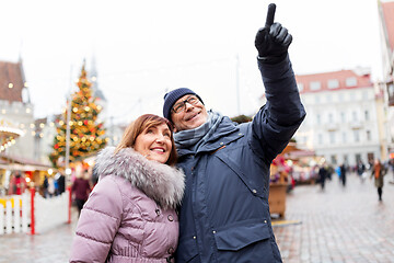 Image showing happy senior couple hugging at christmas market