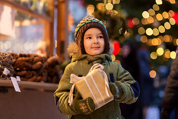 Image showing happy boy with gift box at christmas market