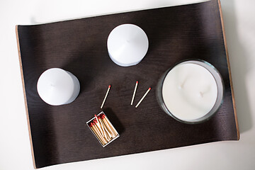 Image showing fragrance candles and matches on tray on table