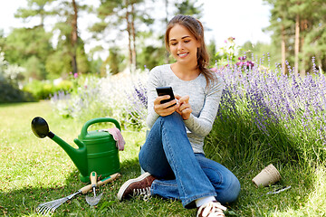 Image showing woman with smartphone and garden tools in summer