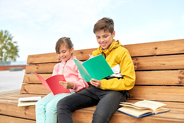 Image showing school children with notebooks sitting on bench