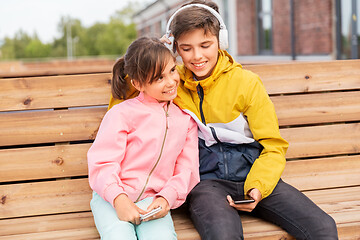 Image showing bou and girl with headphones listening to music