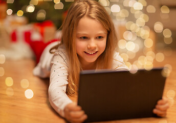 Image showing smiling girl with tablet pc at christmas home