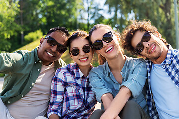 Image showing happy friends taking selfie at summer park