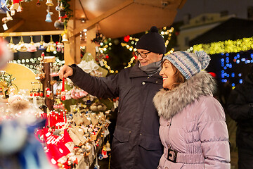 Image showing happy senior couple hugging at christmas market