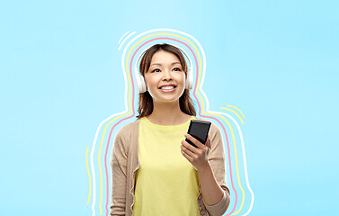 Image showing asian woman in headphones listening to music