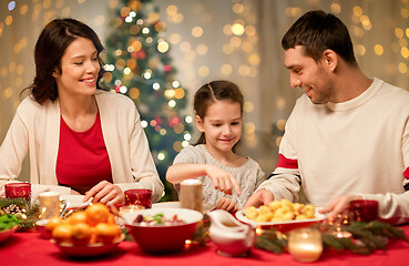 Image showing happy family having christmas dinner at home